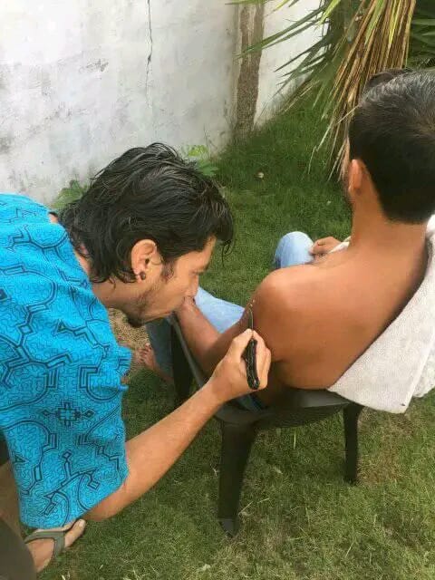 Practitioner applying the Kambo secretion during a session