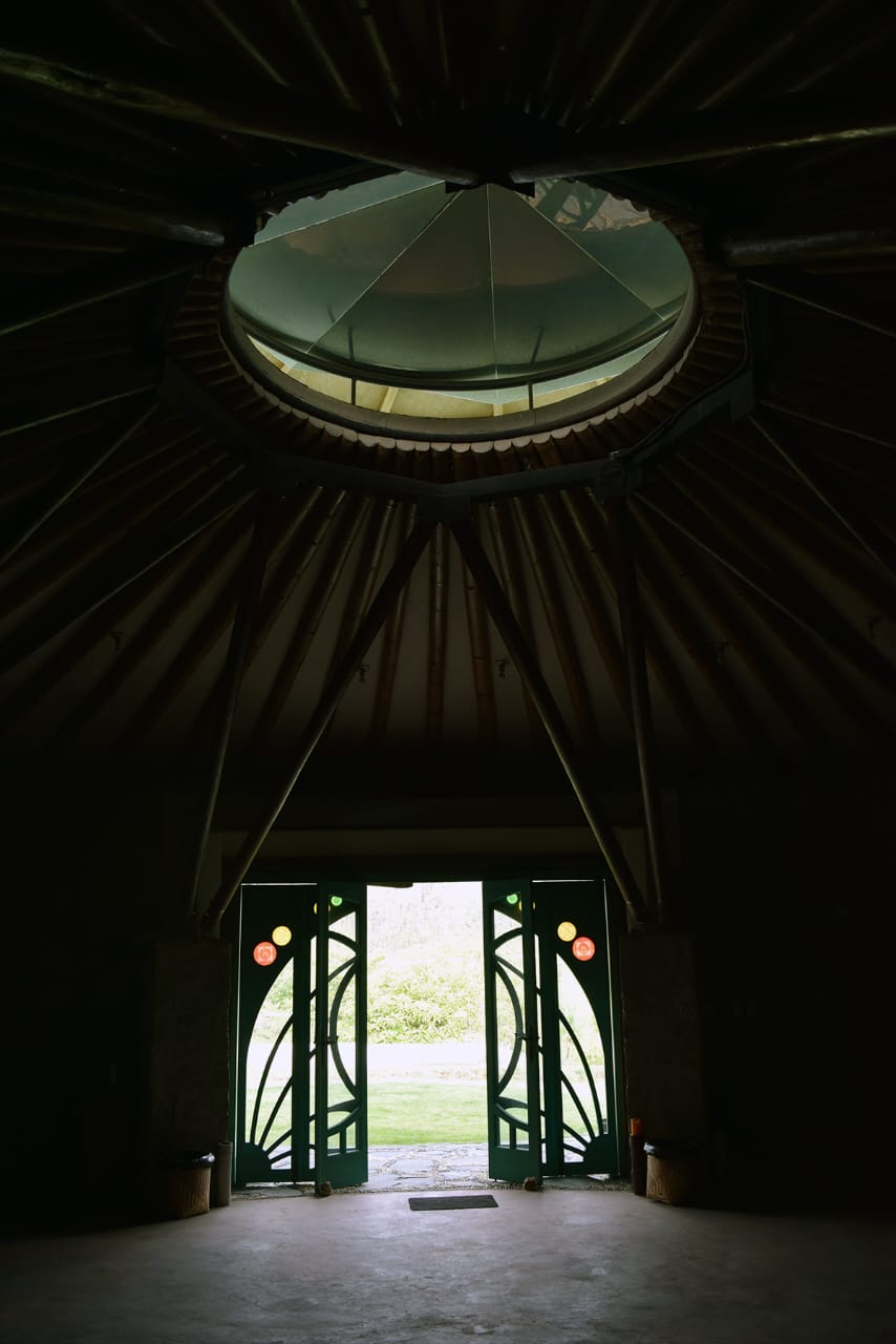 Inside the maloka — bamboo dome ceiling and ceremonial doors