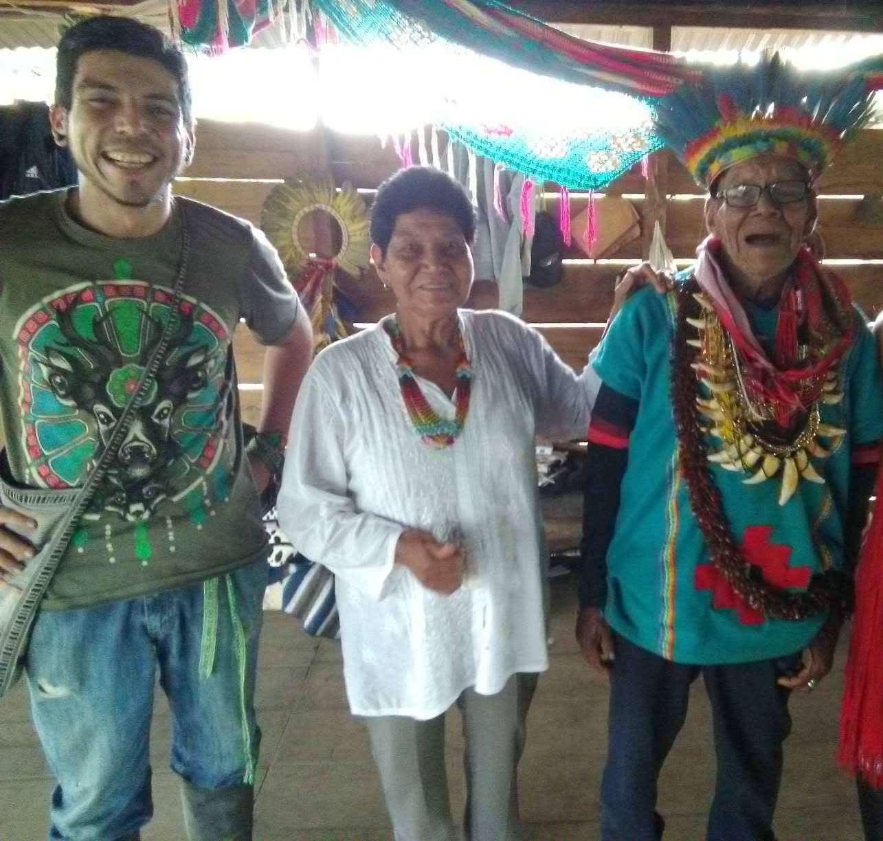 Gabriel with elder Indigenous medicine carriers inside a traditional maloka