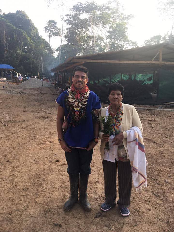 Gabriel beside an Indigenous elder in the Amazon at sunrise, after ceremony