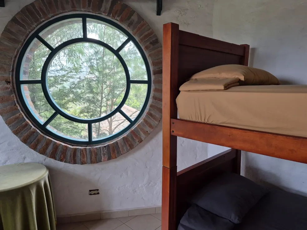 Wood-beamed kitchen at Teos with traditional clay wood-fired oven